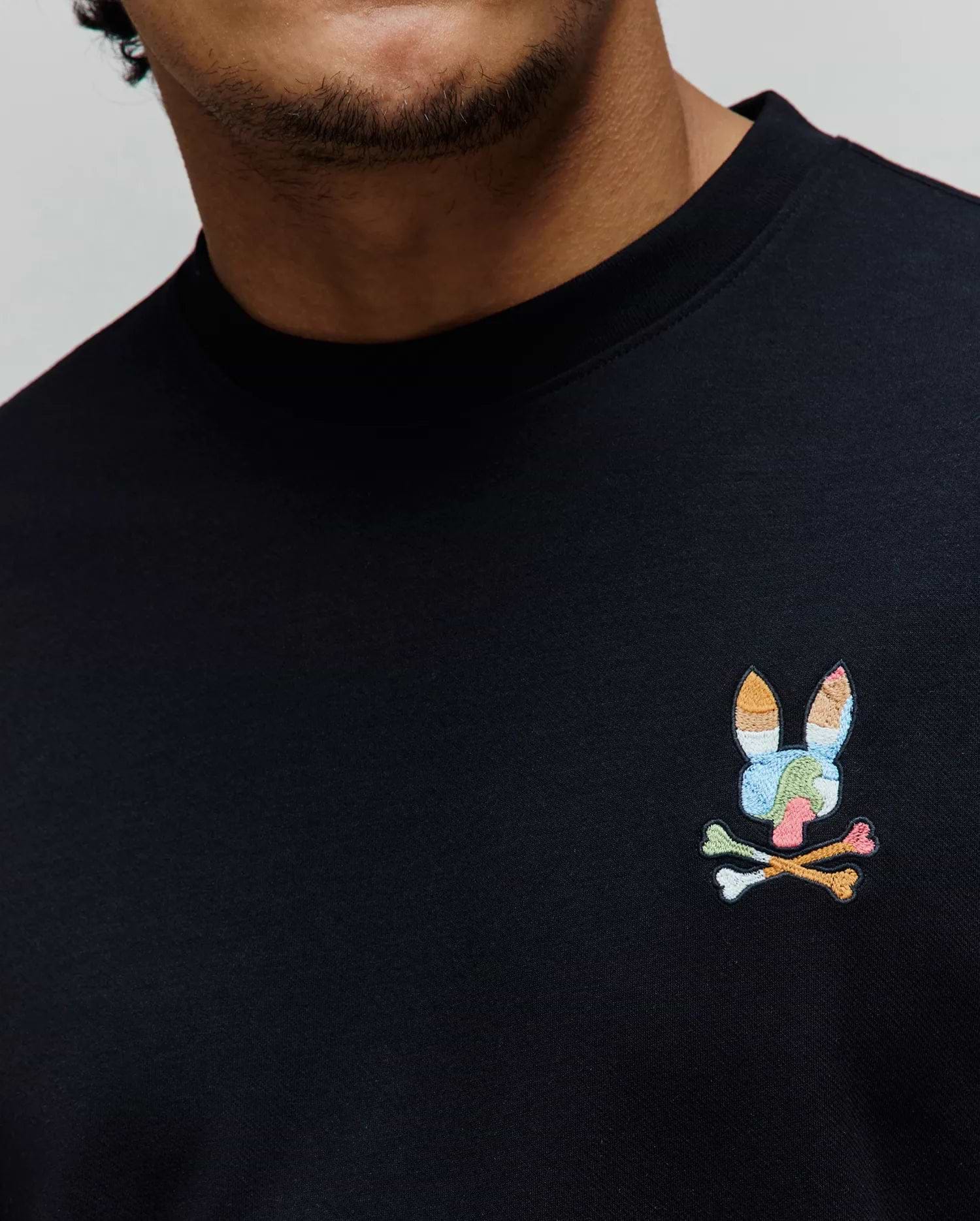 Black Mens Ara Oversized Tee in smooth jersey knit, featuring a small, vibrant multicolor embroidered Psycho Bunny skull logo on the left chest.