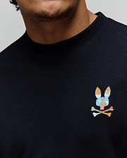 Black Mens Ara Oversized Tee in smooth jersey knit, featuring a small, vibrant multicolor embroidered Psycho Bunny skull logo on the left chest.