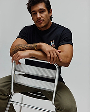 Black Mens Ara Oversized Tee in soft jersey, featuring a small, vibrant multi-color embroidered Psycho Bunny skull logo on the left chest for a relaxed fit.