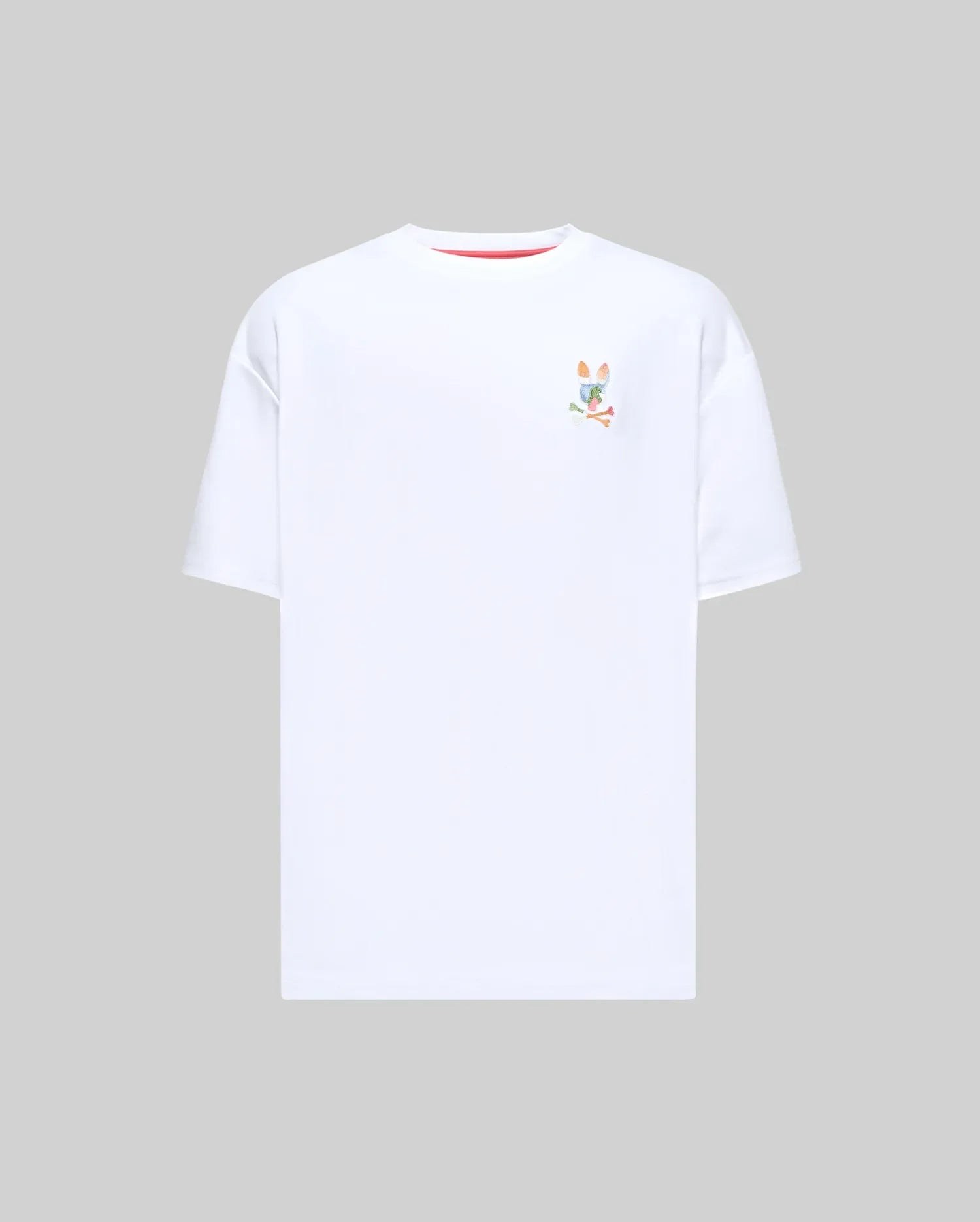 Mens Ara Oversized Tee, a white oversized jersey t-shirt featuring a small, multicolor embroidered Psycho Bunny skull logo on the left chest and subtle red collar trim. (4)