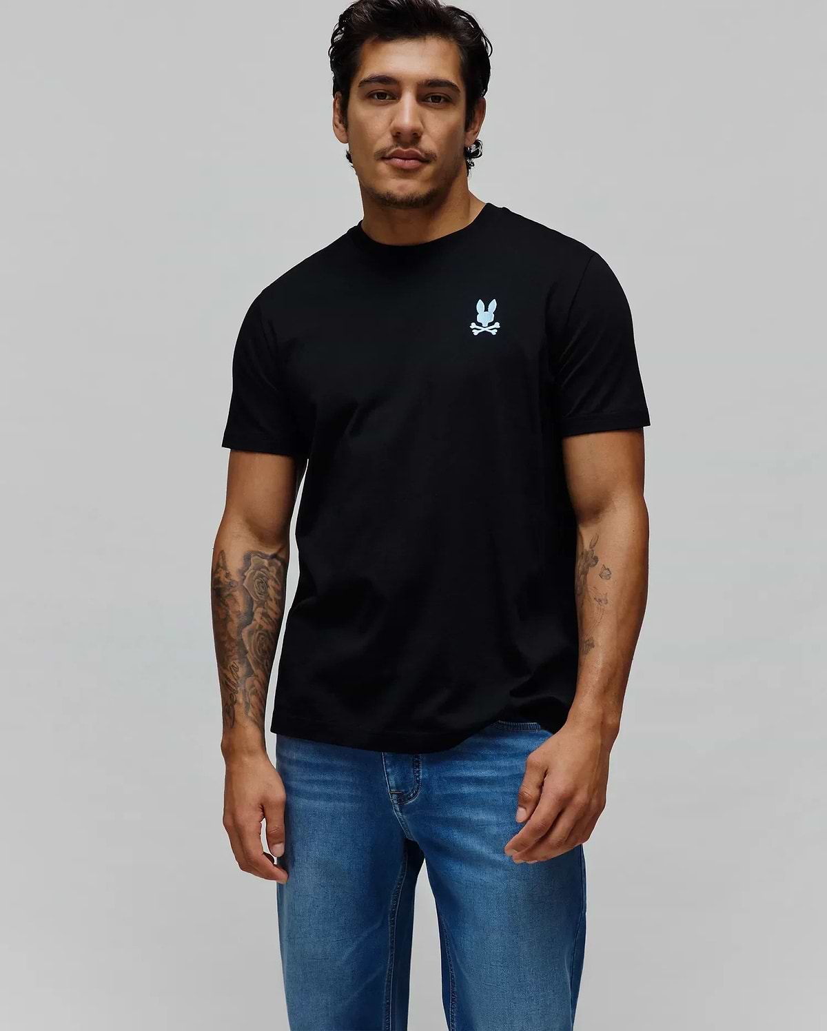 Mens Aiden Back Graphic Tee, a black classic fit smooth jersey knit t-shirt featuring a small light blue Psycho Bunny skull logo on the left chest, embodying premium streetwear. (2)
