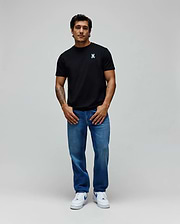 Black Mens Aiden Back Graphic Tee in classic fit jersey with a small light blue embroidered Psycho Bunny skull logo on the left chest, paired with relaxed fit medium wash blue denim jeans. (4)