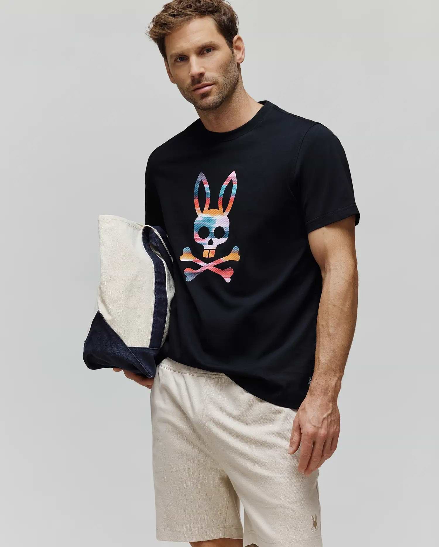 Mens Raphael Graphic Tee, a black classic-fit jersey t-shirt with a large multicolor bunny skull graphic on the chest, paired with light beige relaxed-fit pique shorts featuring a small embroidered bunny logo. (2)
