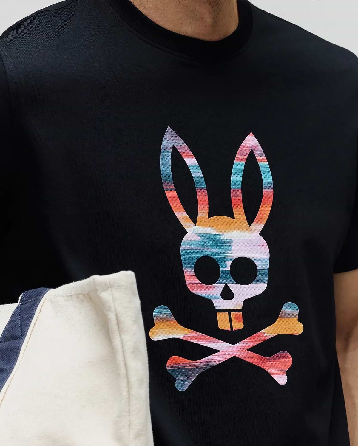 Mens Raphael Graphic Tee, a classic fit black jersey knit t-shirt featuring a large, vibrant, multi-color Psycho Bunny skull and crossbones graphic print on the chest. (3)