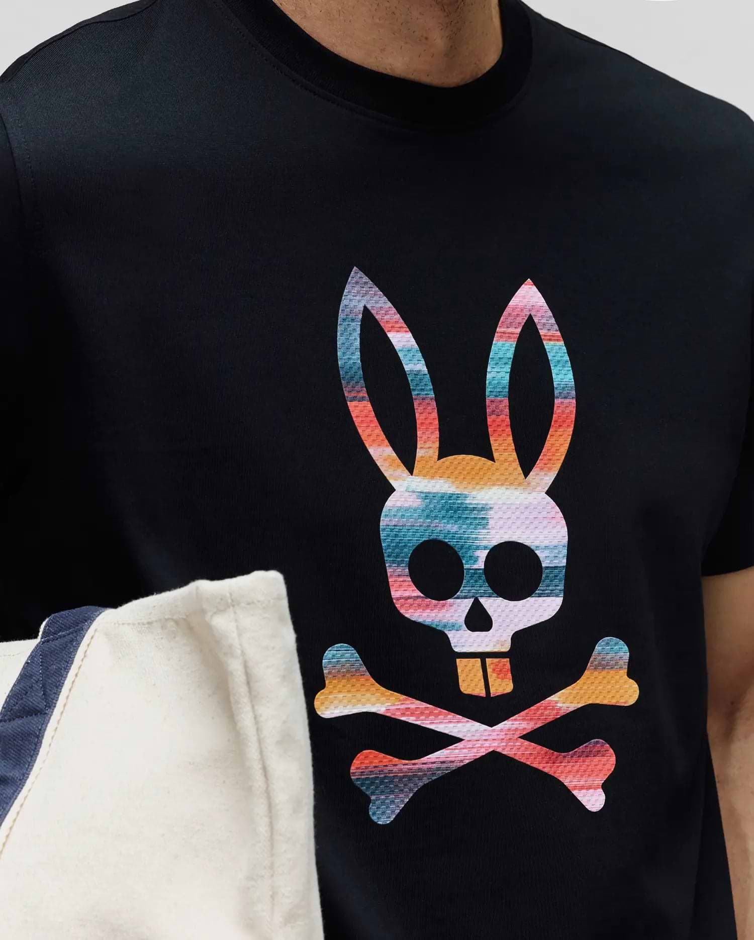 Mens Raphael Graphic Tee, a classic fit black jersey knit t-shirt featuring a large, vibrant, multi-color Psycho Bunny skull and crossbones graphic print on the chest. (3)