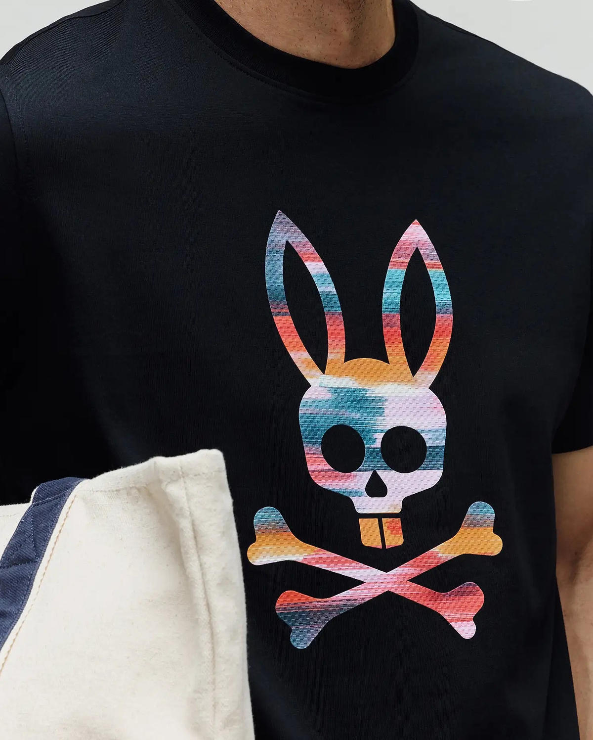 Mens Raphael Graphic Tee, a classic fit black jersey knit t-shirt featuring a large, vibrant, multi-color Psycho Bunny skull and crossbones graphic print on the chest. (3)