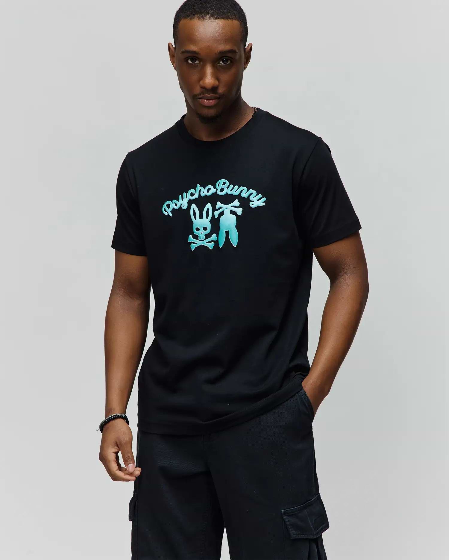 Black Mens Aram Graphic Tee in classic fit jersey, featuring a large teal gradient Psycho Bunny skull and crossbones logo with script text on the chest. (2)