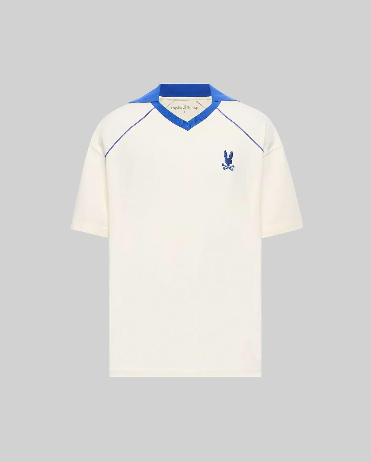 Mens Toby Jersey, a cream relaxed fit jersey with a royal blue V-neck collar, raglan piping, and a small embroidered royal blue Psycho Bunny skull logo on the left chest. (5)
