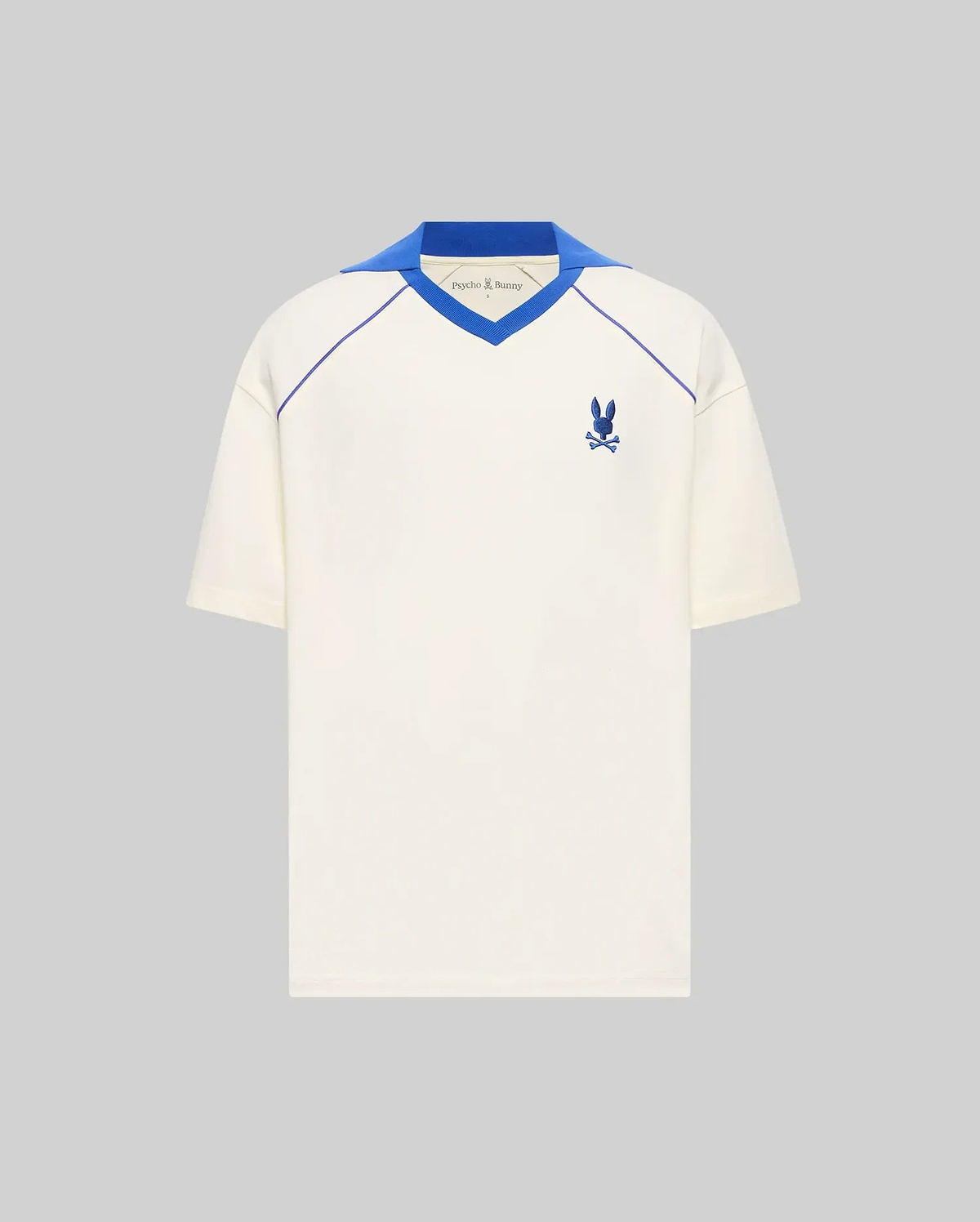 Mens Toby Jersey, a cream relaxed fit jersey with a royal blue V-neck collar, raglan piping, and a small embroidered royal blue Psycho Bunny skull logo on the left chest. (5)
