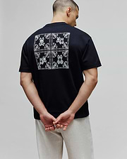 Black Mens Luke Back Graphic Tee in soft jersey, classic fit, featuring a large white bandana-style graphic on the back with four Psycho Bunny skull logos and paisley patterns.