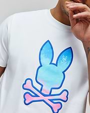 Mens Caspian Graphic Tee, white classic fit jersey t-shirt with a large central blue-to-pink gradient puffy print Psycho Bunny skull and crossbones graphic, outlined in dark blue, featuring a smaller white logo in the ear.