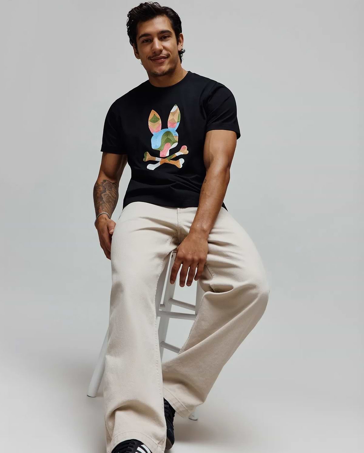 Mens Ara Graphic Tee in black, a classic fit soft jersey t-shirt featuring a large, multicolor graphic bunny skull logo prominently displayed on the center chest, showcasing iconic Psycho Bunny branding. (4)