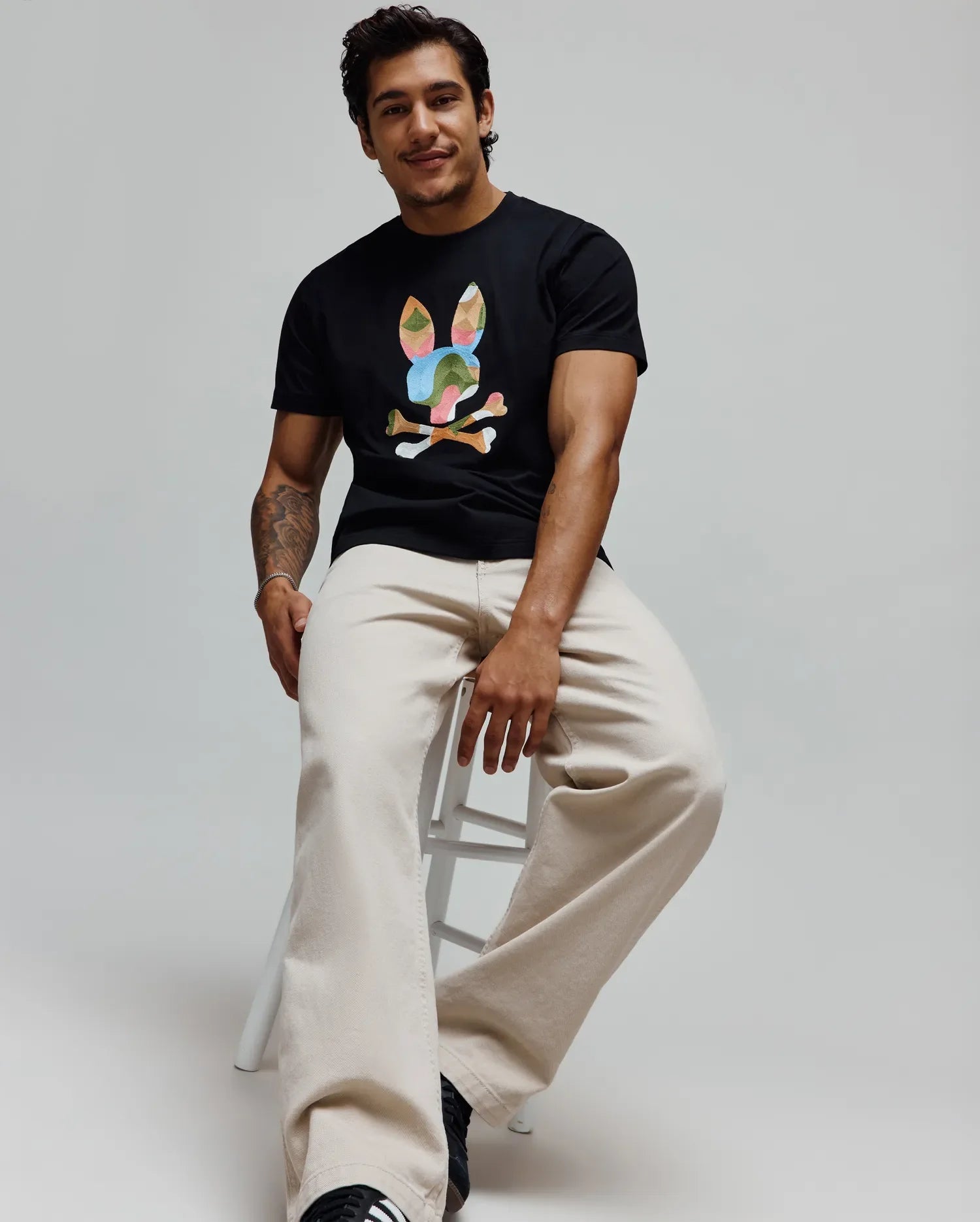 Mens Ara Graphic Tee in black, a classic fit soft jersey t-shirt featuring a large, multicolor graphic bunny skull logo prominently displayed on the center chest, showcasing iconic Psycho Bunny branding. (4)