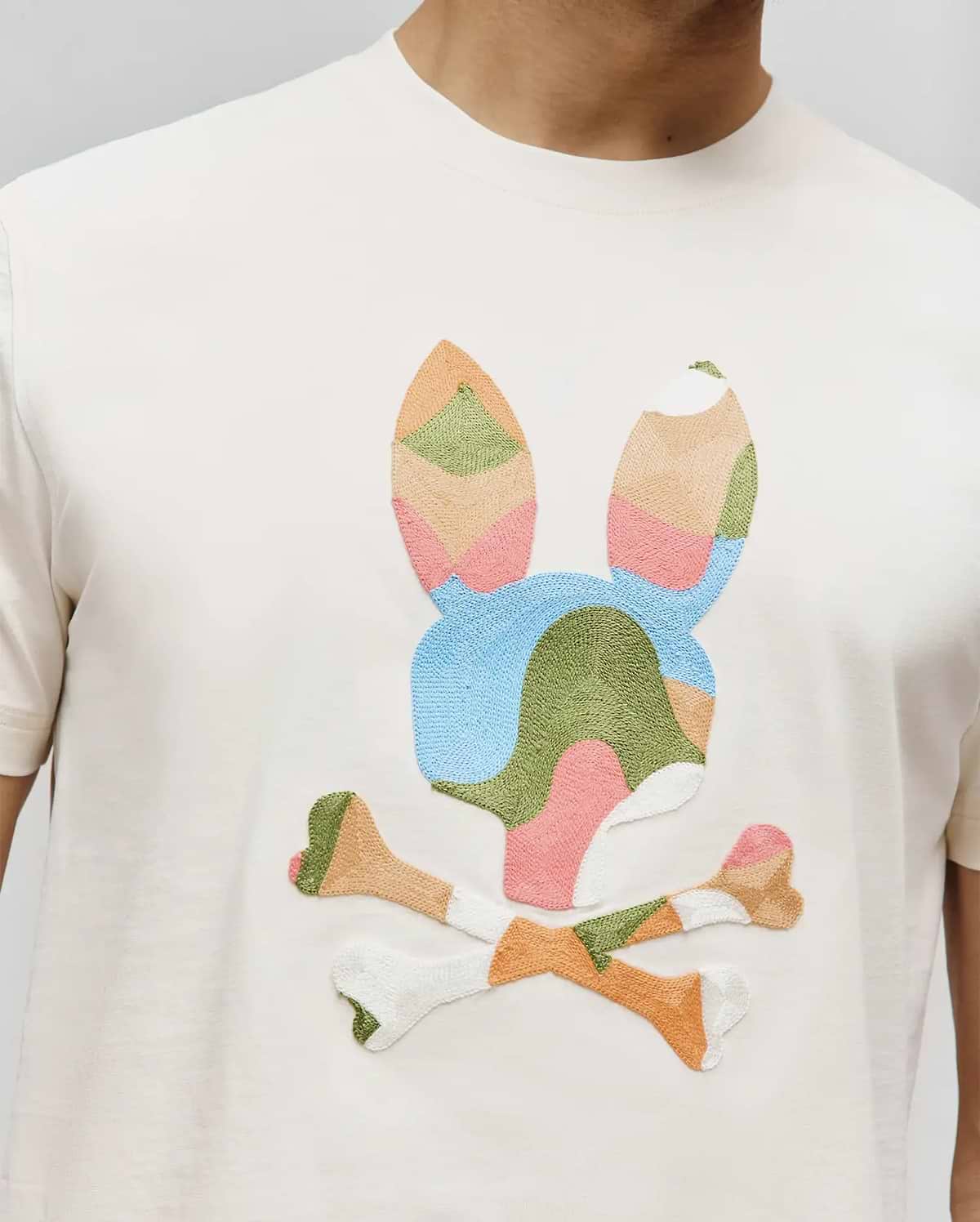 Mens Ara Graphic Tee, cream classic fit jersey knit with a large, central multi-color embroidered geometric patchwork bunny skull logo. (3)