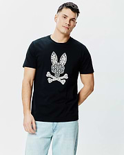 Black Mens Brad Graphic Tee, a classic fit jersey t-shirt with a large, centered white Psycho Bunny skull logo intricately patterned with small palm trees and motifs. (2)