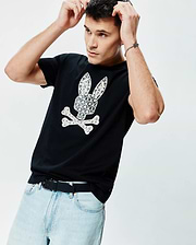 Mens Brad Graphic Tee, black cotton jersey, classic fit, featuring a large white Psycho Bunny skull and crossbones graphic on the chest with a detailed palm tree and mini bunny skull pattern. (4)