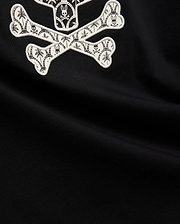 Mens Brad Graphic Tee, black smooth jersey with a large white embroidered Psycho Bunny skull and crossbones graphic, featuring tropical palm trees and mini bunny skulls within the bones. (6)
