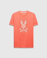 Mens Brad Graphic Tee, a coral classic fit jersey t-shirt featuring a large center chest Psycho Bunny skull and crossbones logo filled with a white tropical palm tree pattern.