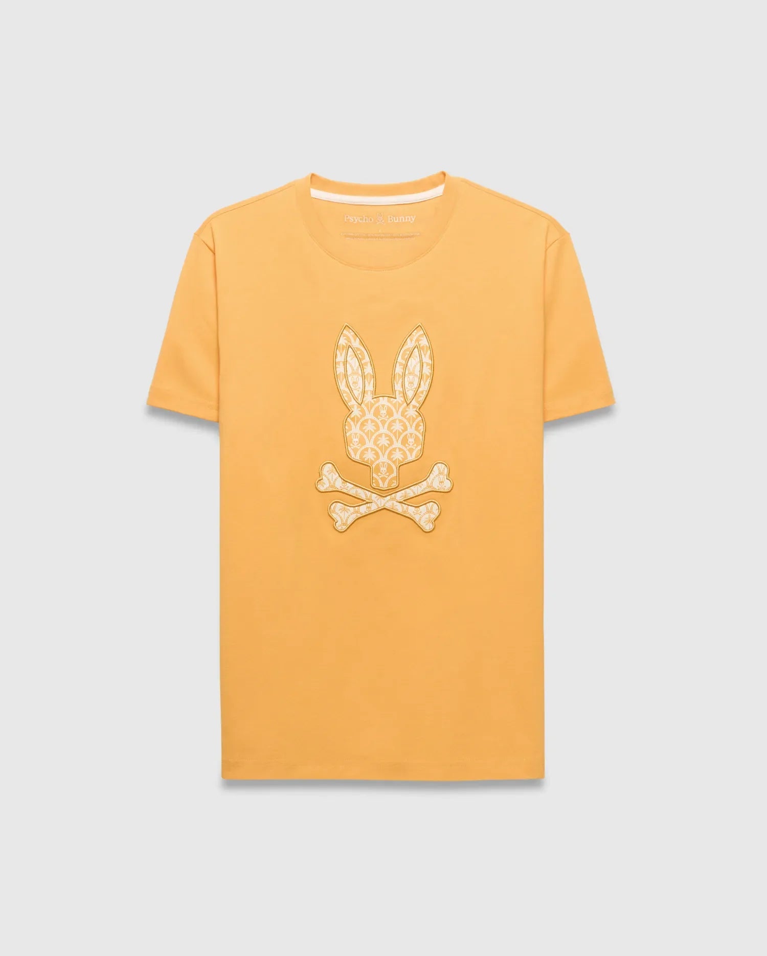 Mens Brad Graphic Tee, marigold yellow classic fit jersey t-shirt with a large cream repeating Psycho Bunny logo pattern graphic on the chest and a small logo on the back neck.