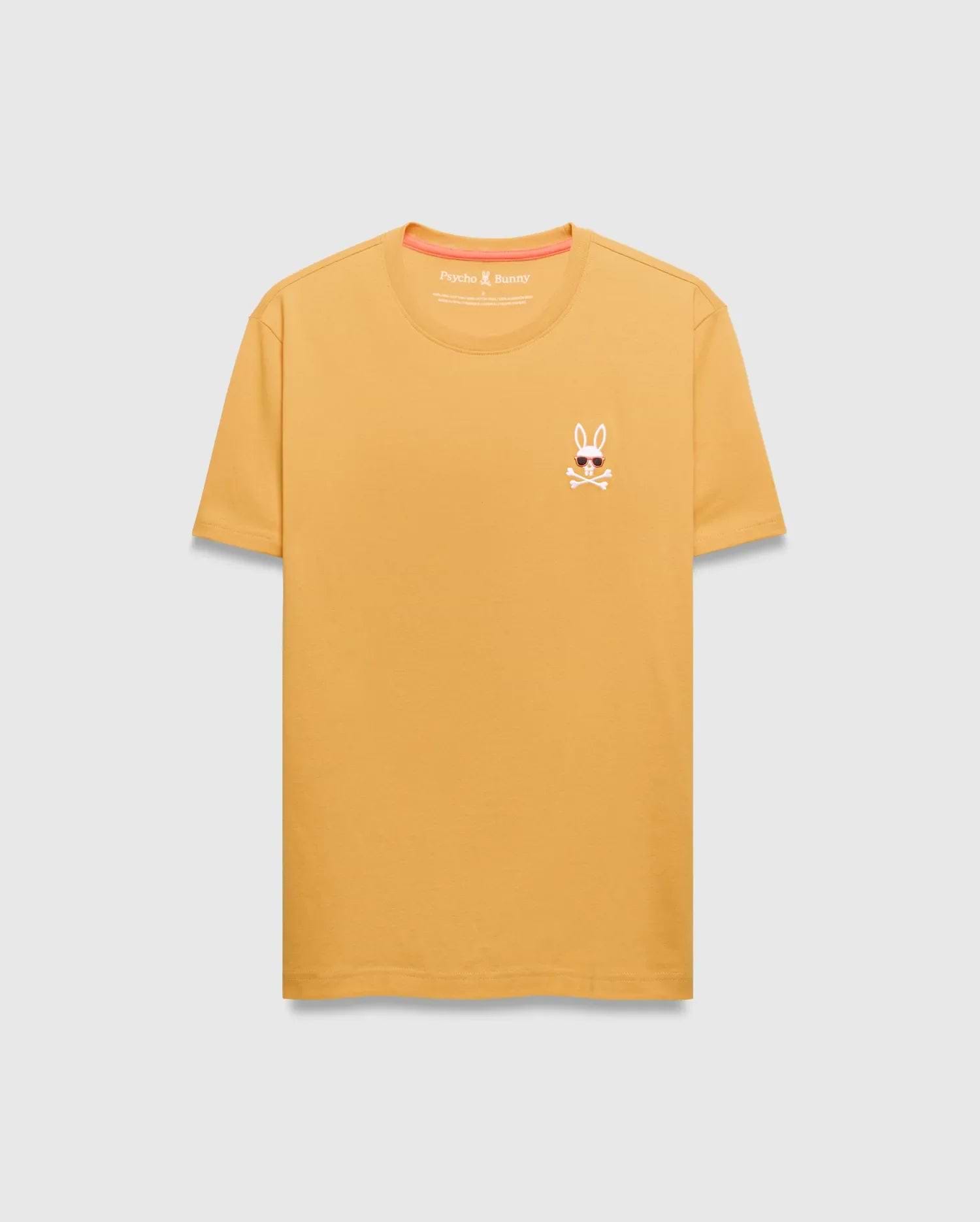 Mens Sunny Chest Graphic Tee. Golden yellow classic fit jersey t-shirt with a small embroidered Psycho Bunny skull logo wearing sunglasses on the left chest, featuring orange neck tape. (1)