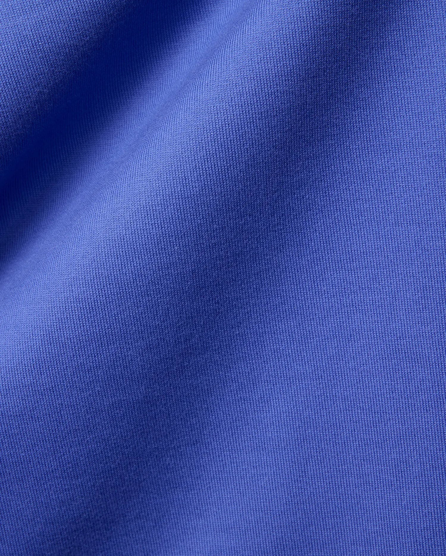 Mens Craig Wordmark Tee crafted from a premium, vibrant blue jersey knit fabric, showcasing a smooth texture with subtle vertical ribbing and elegant, soft folds. (6)