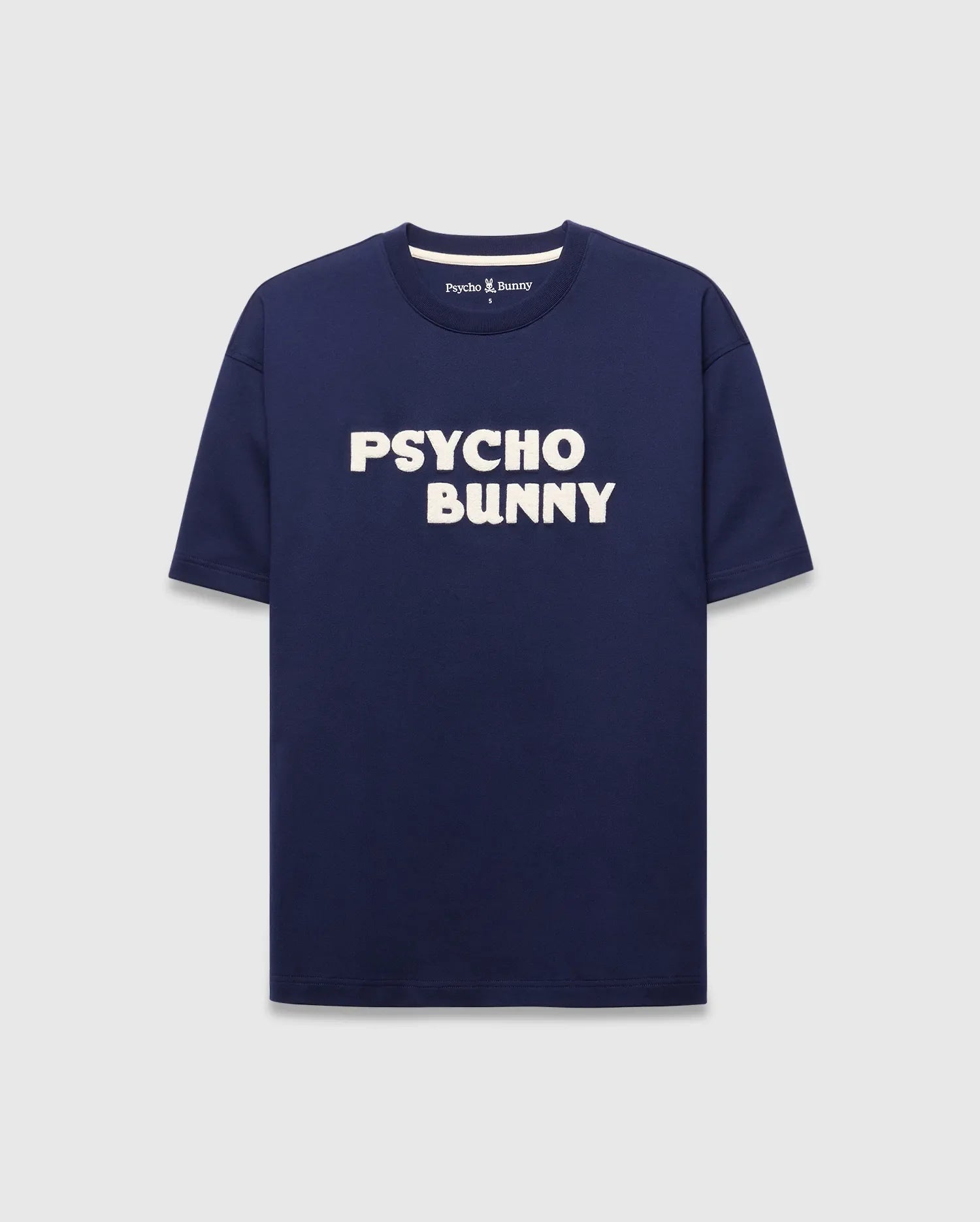 Mens Craig Wordmark Tee, a navy blue relaxed fit jersey t-shirt featuring a bold white PSYCHO BUNNY chest wordmark and a small Psycho Bunny logo on the inner back neck. (5)