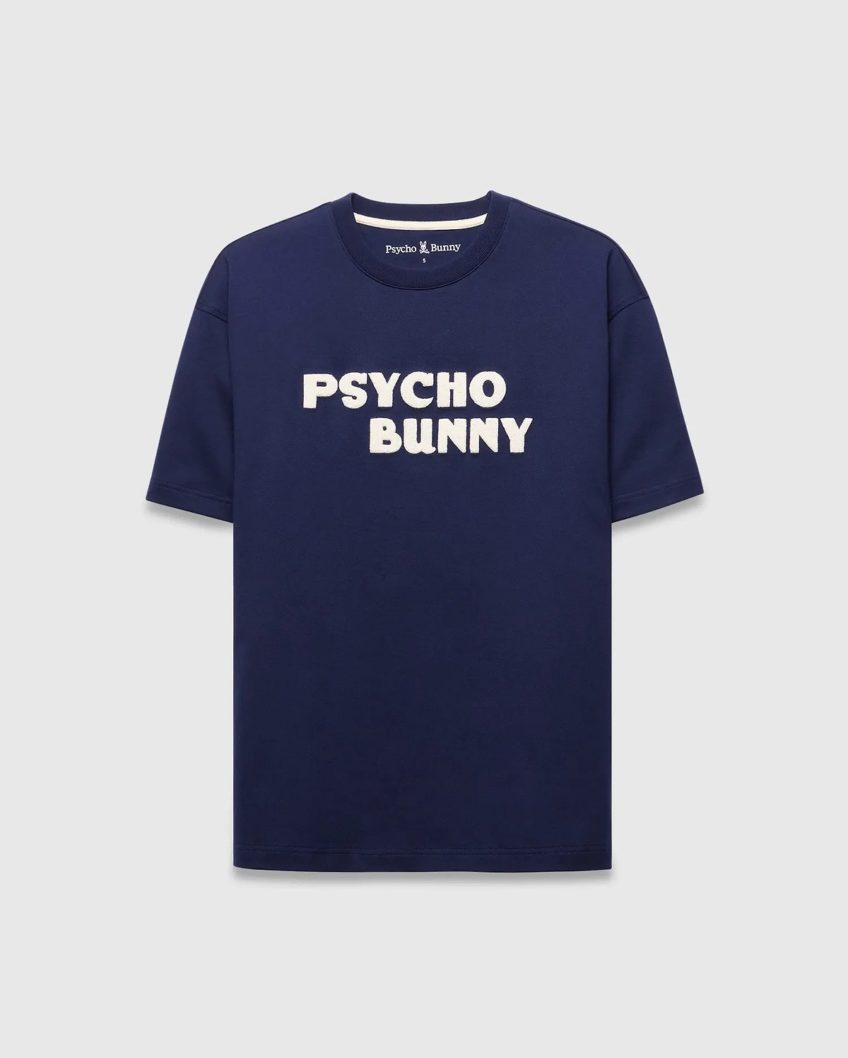 Mens Craig Wordmark Tee, a navy blue relaxed fit jersey t-shirt featuring a bold white PSYCHO BUNNY chest wordmark and a small Psycho Bunny logo on the inner back neck. (5)