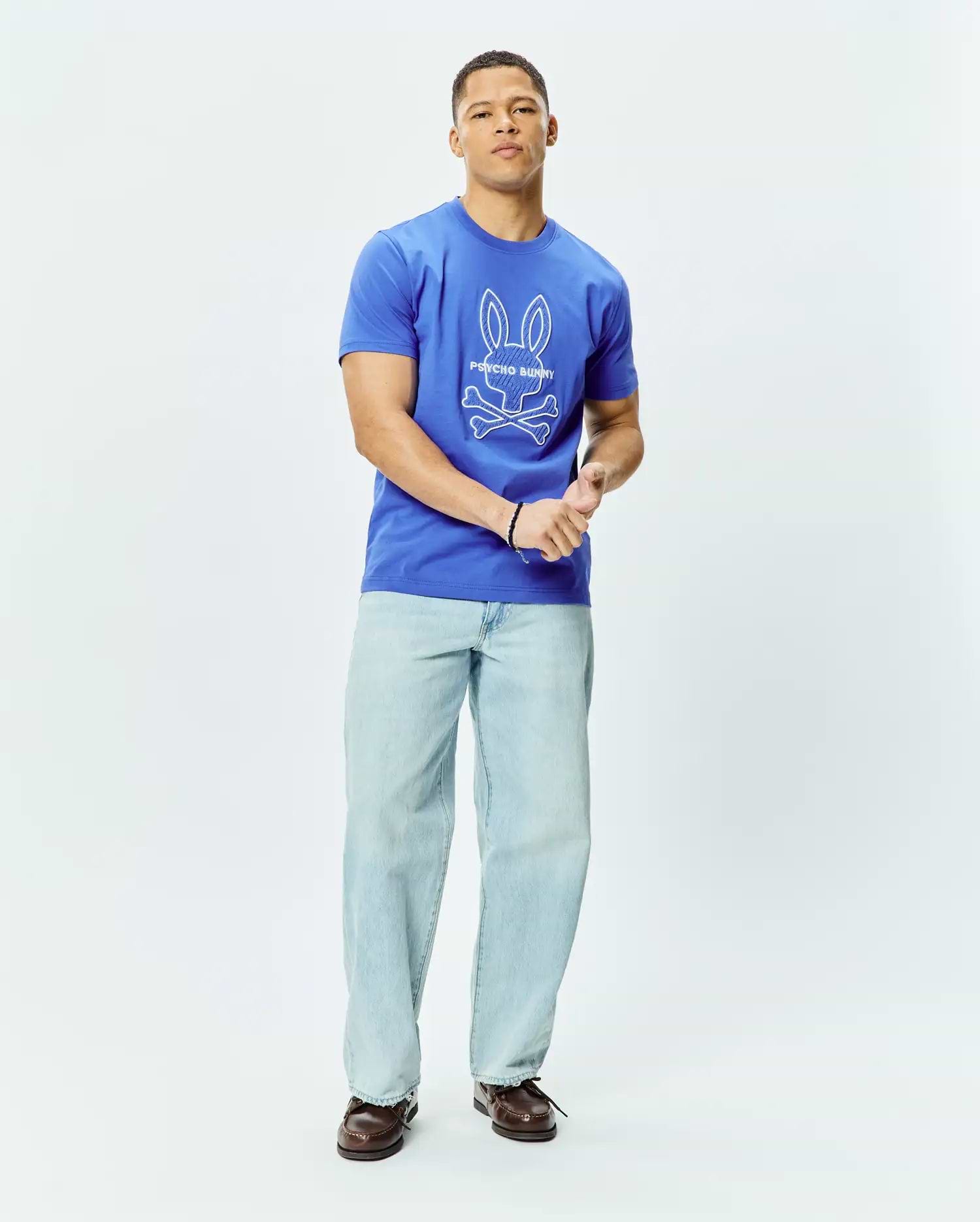 Mens Craig Graphic Tee, a royal blue classic fit jersey t-shirt featuring a large white Psycho Bunny skull and crossbones graphic logo centered on the chest. (4)