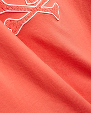 Mens Craig Graphic Tee in coral, made from soft jersey knit, featuring a large embroidered Psycho Bunny skull logo with a white outline and textured coral fill. (2)