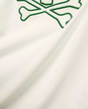 Mens Craig Graphic Tee in cream soft jersey knit, featuring a large embroidered green outline bunny skull crossbones with white terry texture. (5)