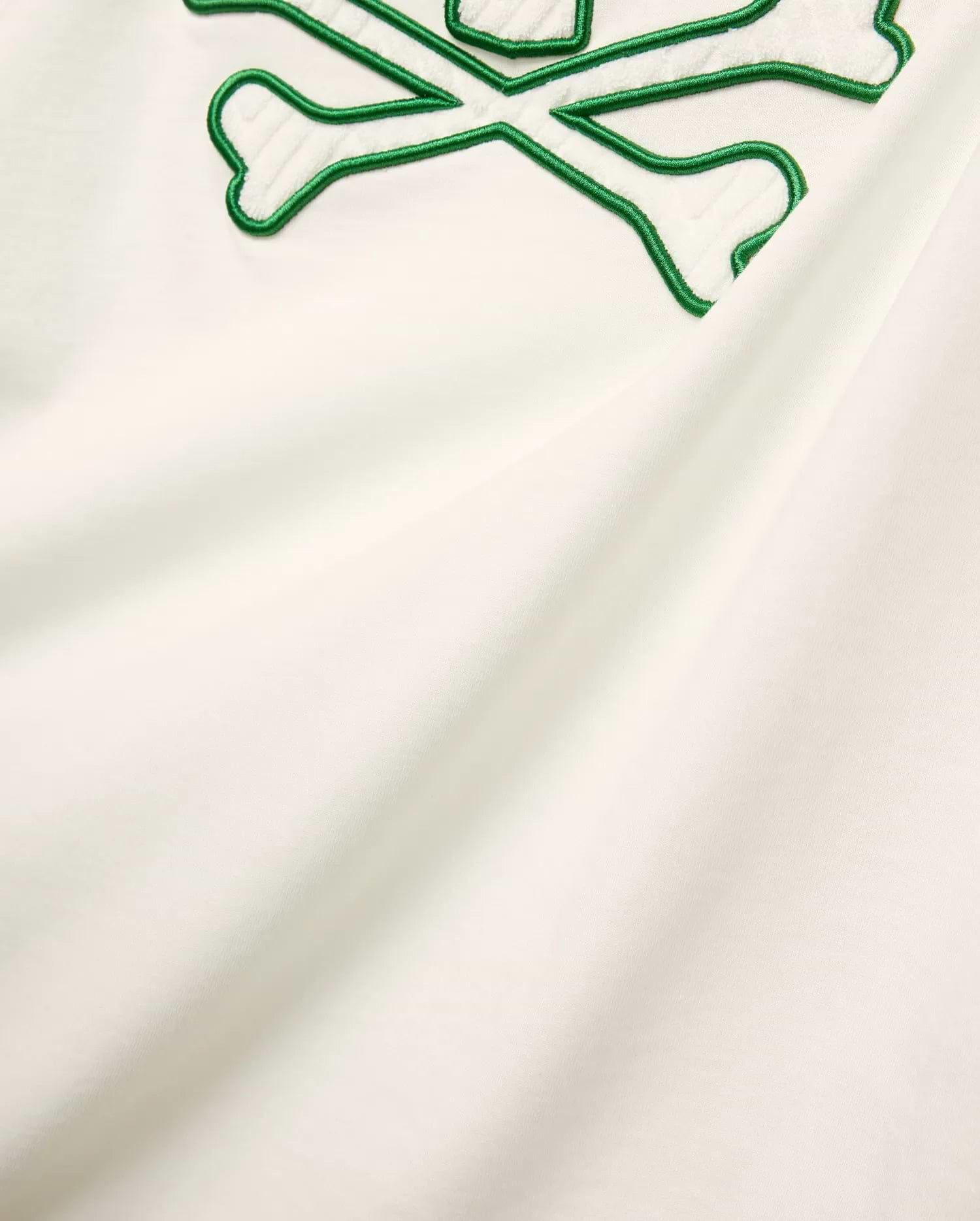 Mens Craig Graphic Tee in cream soft jersey knit, featuring a large embroidered green outline bunny skull crossbones with white terry texture. (5)