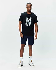 Mens Tanner Graphic Tee, a black classic fit jersey t-shirt featuring a large central chest graphic of multiple white and grey Psycho Bunny skull logos with crossbones.