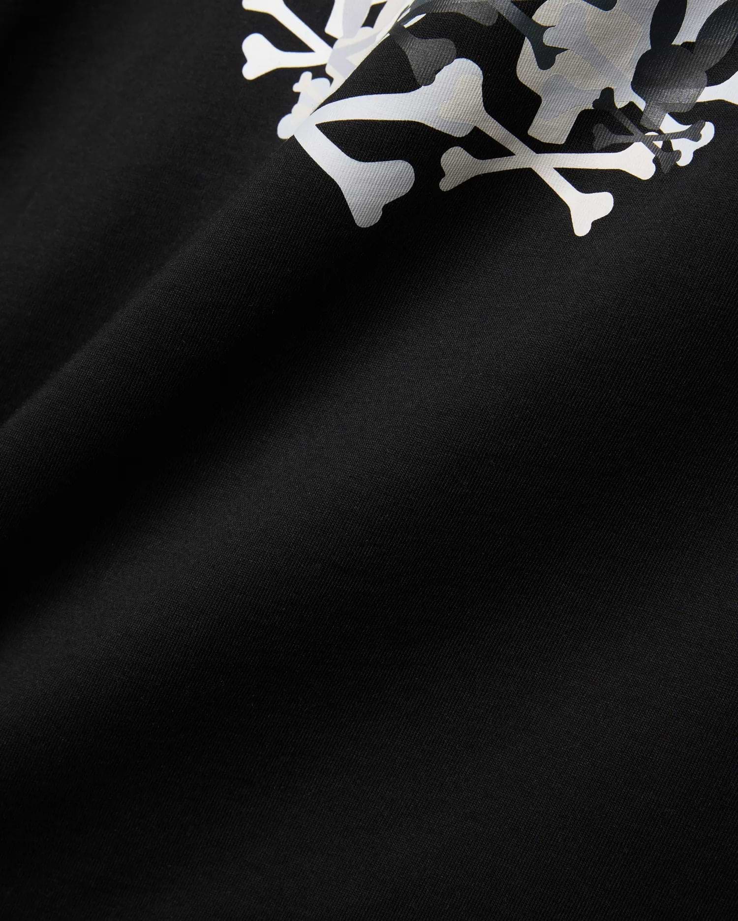 Mens Tanner Graphic Tee, black jersey knit fabric displaying a prominent, large white and subtle grey camouflage Psycho Bunny iconic bunny skull graphic print.