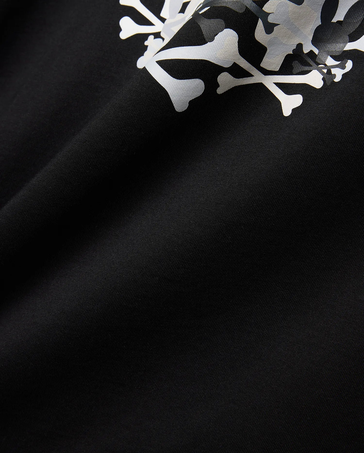 Mens Tanner Graphic Tee, black jersey knit fabric displaying a prominent, large white and subtle grey camouflage Psycho Bunny iconic bunny skull graphic print.