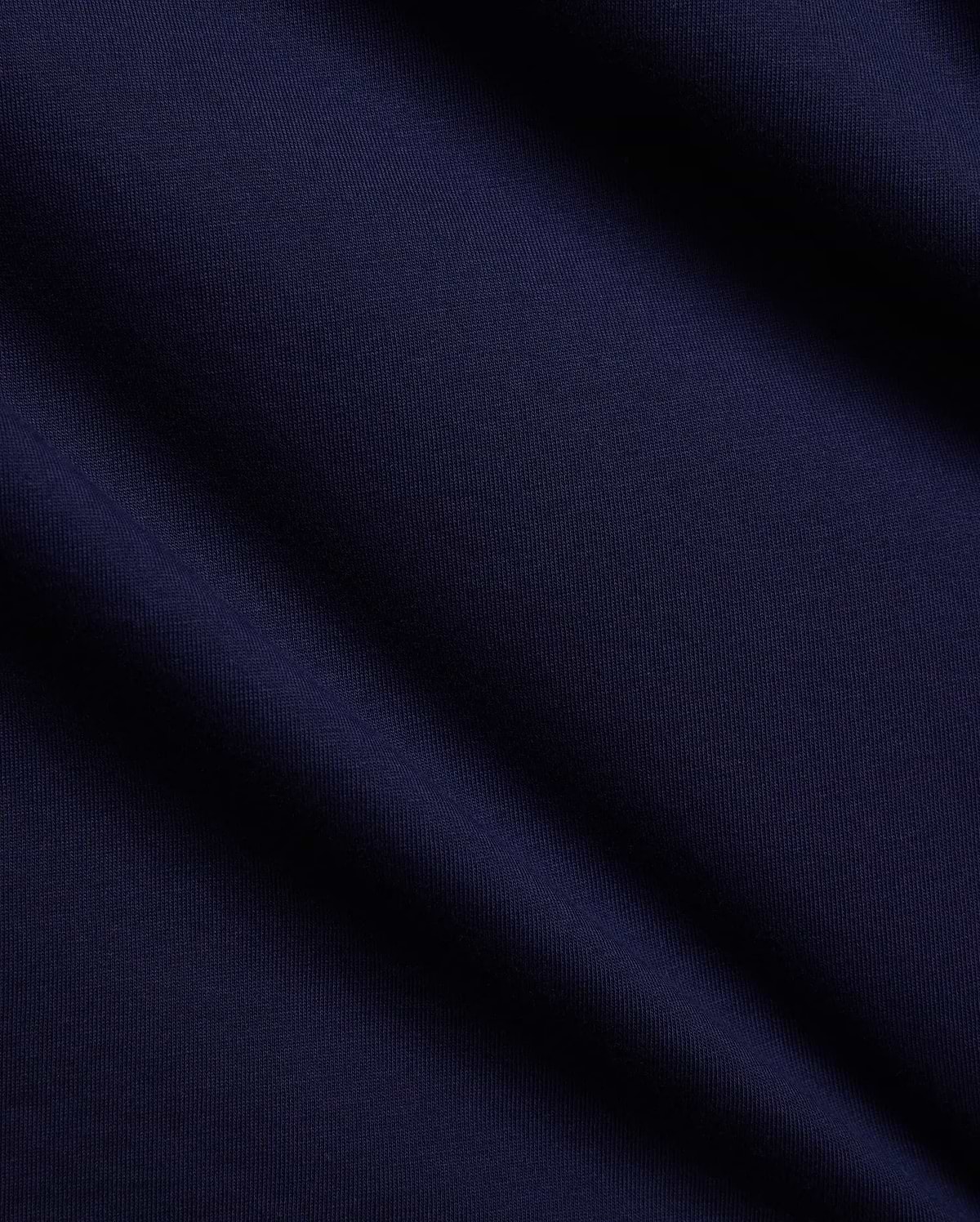 Mens Tanner Graphic Tee in rich navy blue, crafted from soft, finely textured premium jersey knit fabric with elegant folds, suggesting a comfortable, classic fit for refined streetwear.