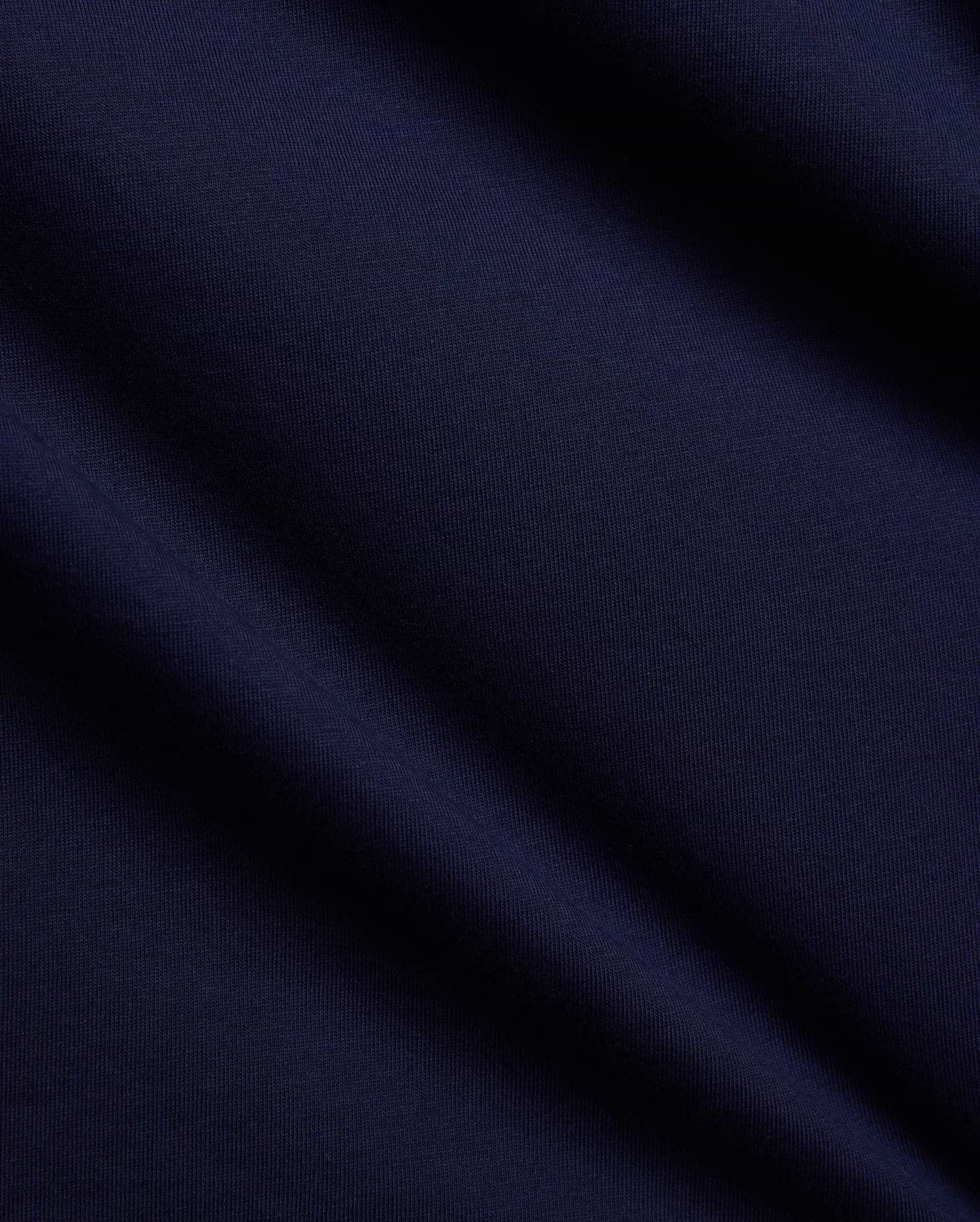 Mens Tanner Graphic Tee in rich navy blue, crafted from soft, finely textured premium jersey knit fabric with elegant folds, suggesting a comfortable, classic fit for refined streetwear.