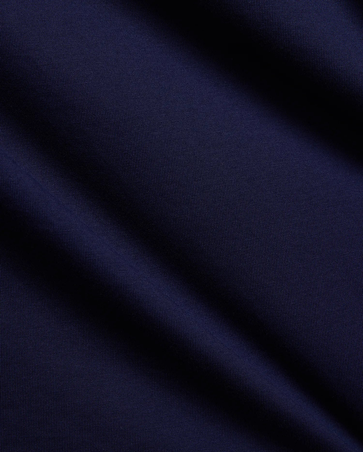 Mens Tanner Graphic Tee in rich navy blue, crafted from soft, finely textured premium jersey knit fabric with elegant folds, suggesting a comfortable, classic fit for refined streetwear.