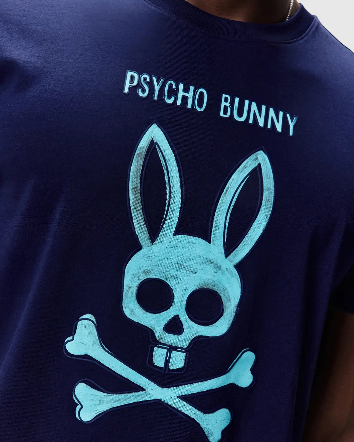 Mens Adler Graphic Tee, navy jersey t-shirt with a large teal Psycho Bunny skull and crossbones graphic on the chest, featuring Psycho Bunny text above. (3)