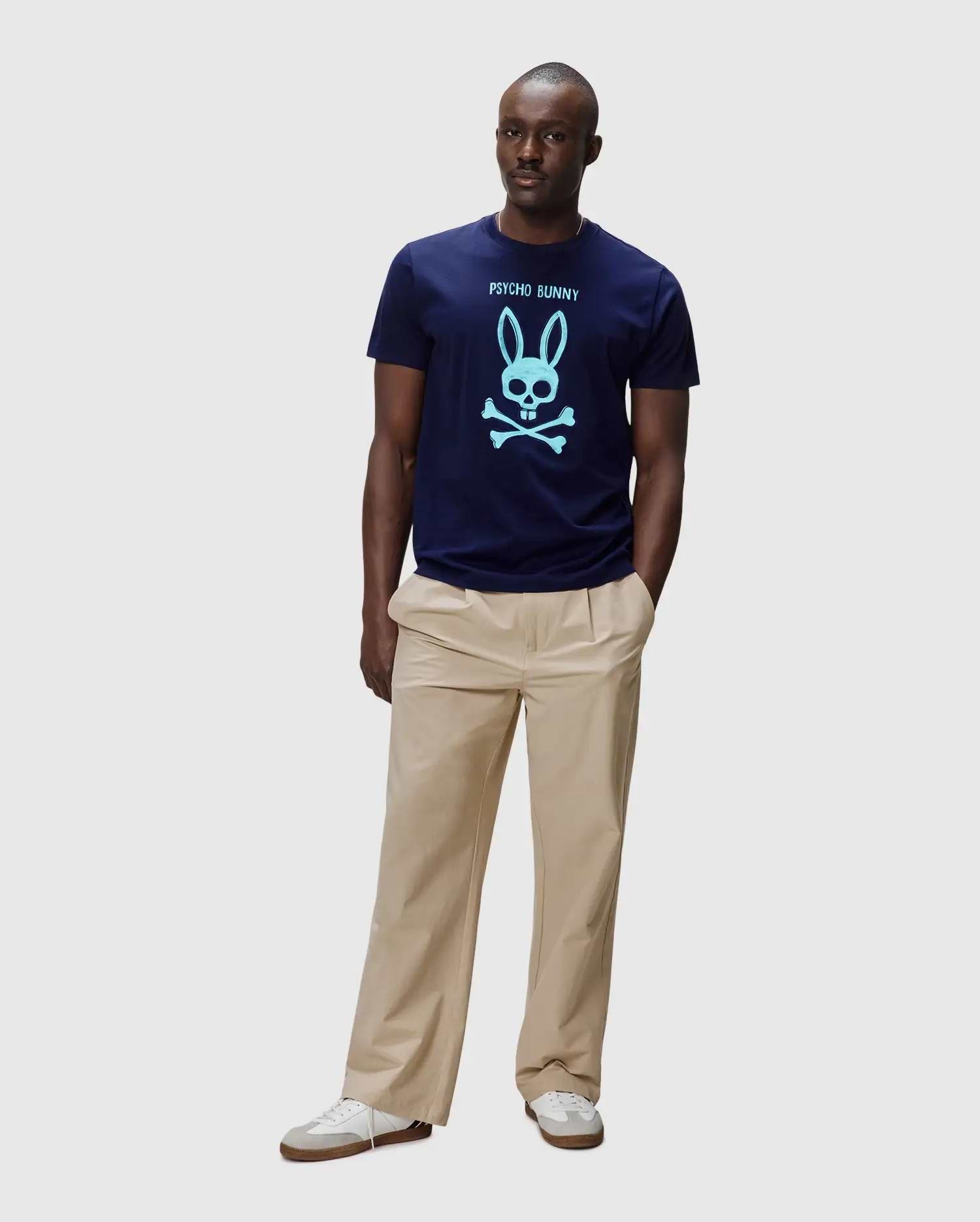 Mens Adler Graphic Tee, navy classic fit jersey t-shirt with a large light blue Psycho Bunny skull and crossbones graphic and brand name on the chest. (4)