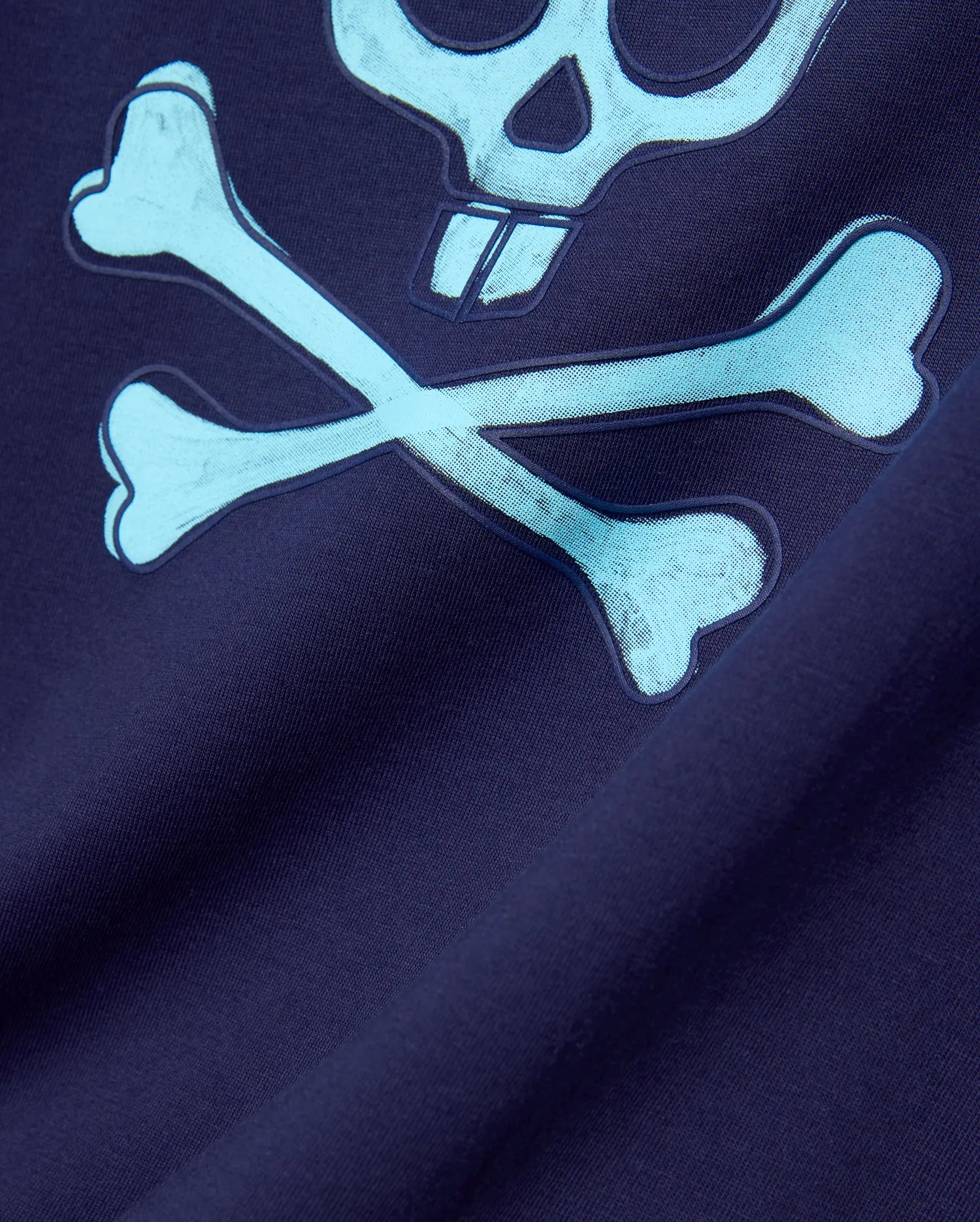 Mens Adler Graphic Tee in navy jersey knit, featuring a large light blue Psycho Bunny skull and crossbones graphic with a textured outline and halftone fill. (5)