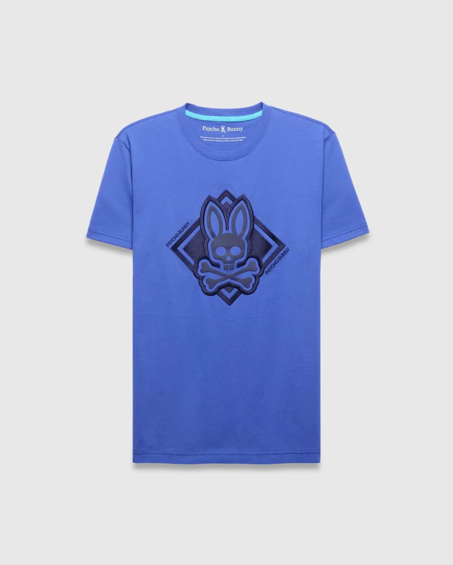 Mens Tobias Graphic Tee, royal blue classic fit jersey t-shirt featuring a large central dark blue textured bunny skull logo within a diamond outline, flanked by diagonal Psycho Bunny text. (1)
