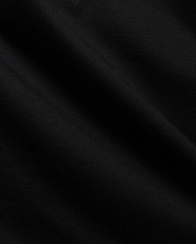 Close-up of the Mens Tobias Graphic Tee in deep black, highlighting its premium, soft cotton jersey knit fabric with subtle, flowing folds and a refined, smooth texture.