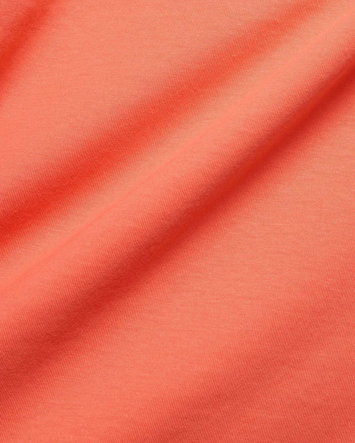 MENS TOBIAS GRAPHIC TEE in a rich, vibrant coral hue, crafted from premium, soft jersey knit fabric with subtle texture and elegant, flowing folds.
