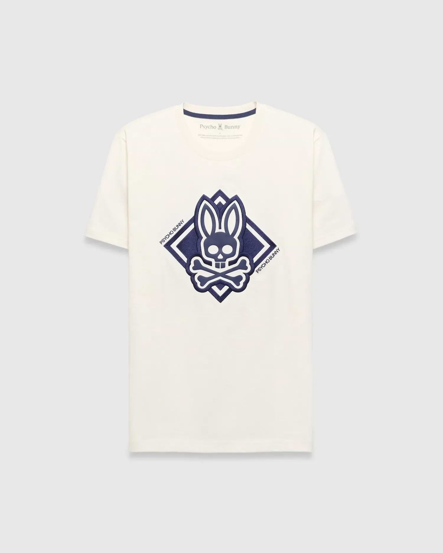 Mens Tobias Graphic Tee, a cream classic fit jersey t-shirt with a large central navy blue Psycho Bunny skull and crossbones logo inside a diamond graphic, featuring Psycho Bunny text.