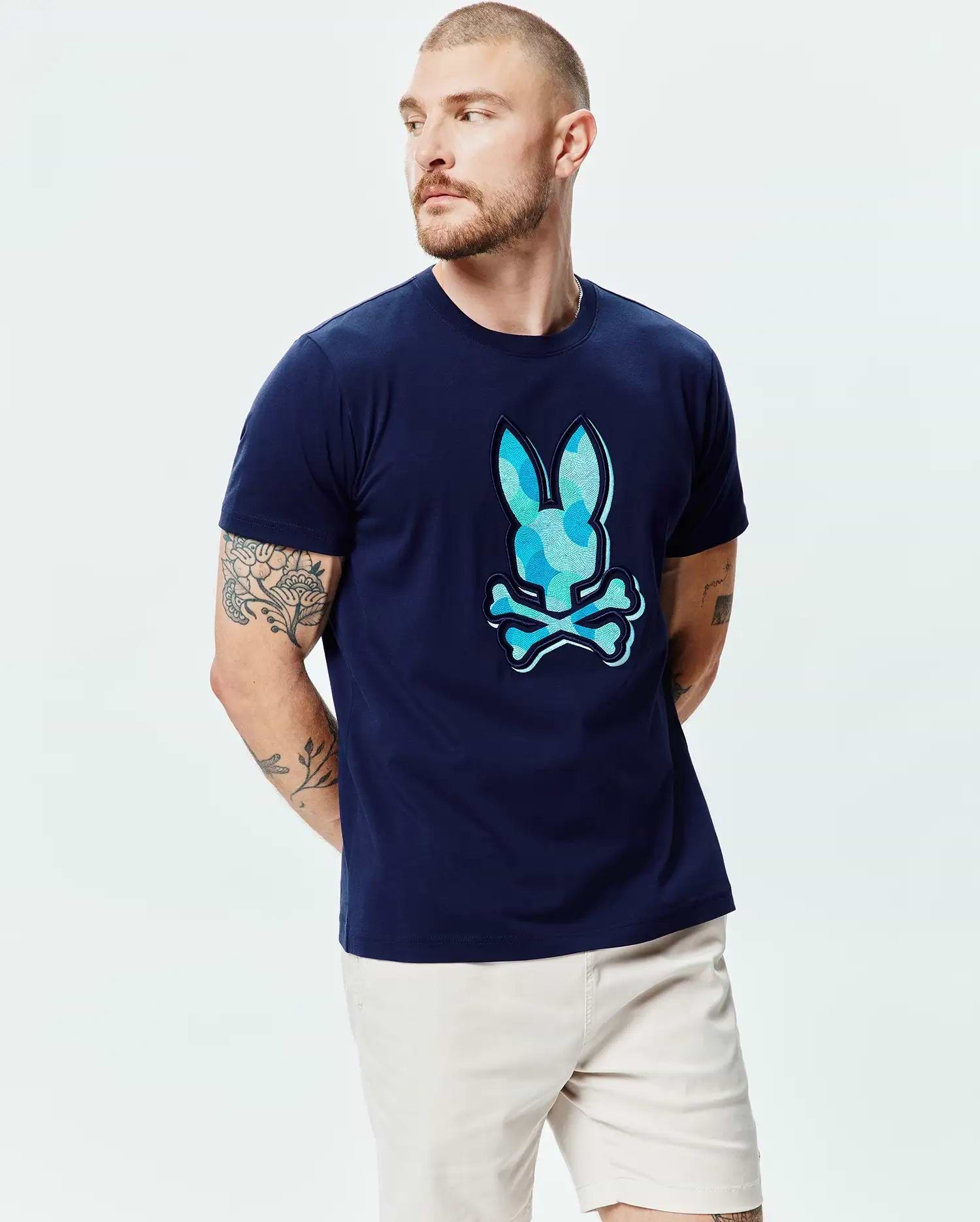 Mens Ethan Graphic Tee, navy classic fit jersey t-shirt with a large center chest Psycho Bunny skull logo featuring a blue and light blue camouflage pattern fill. (3)