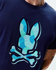 Mens Ethan Graphic Tee. Navy blue jersey t-shirt with a large, textured, mosaic-patterned Psycho Bunny skull logo in shades of blue and teal on the chest, classic fit. (4)