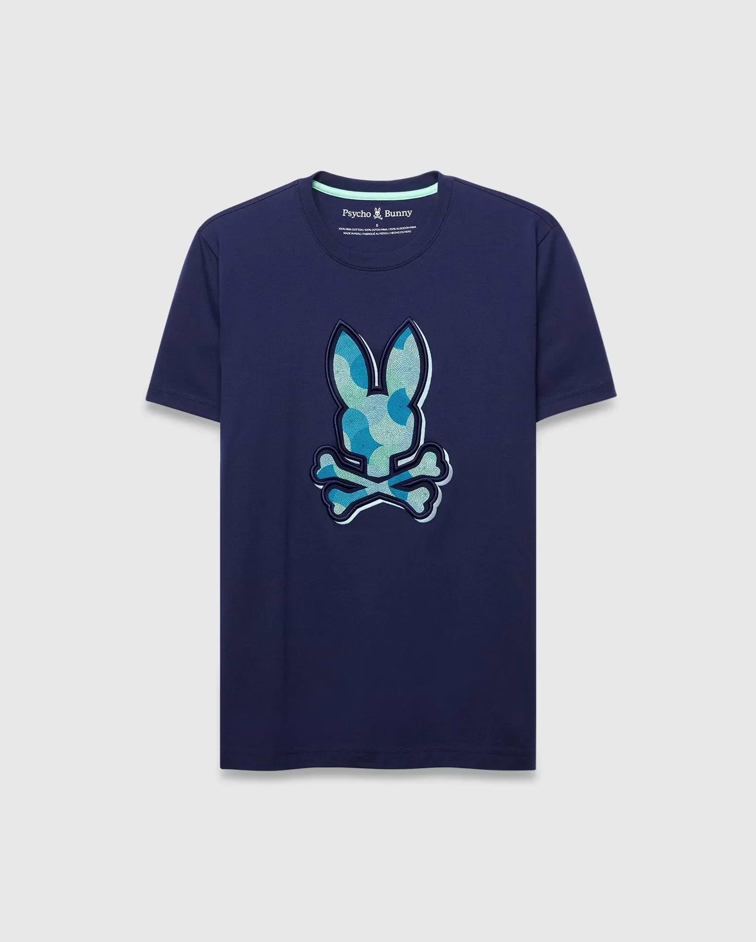Mens Ethan Graphic Tee. Navy classic fit jersey t-shirt with a large center chest Psycho Bunny skull logo featuring a blue and green camouflage pattern, outlined in white. (1)