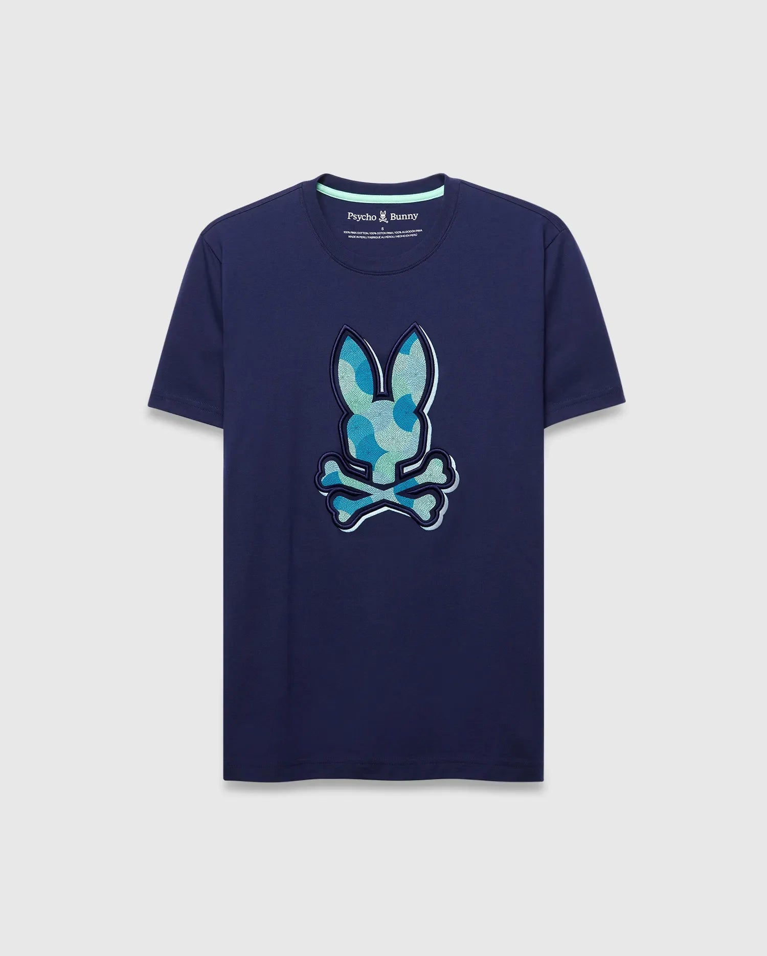 Mens Ethan Graphic Tee. Navy classic fit jersey t-shirt with a large center chest Psycho Bunny skull logo featuring a blue and green camouflage pattern, outlined in white. (1)