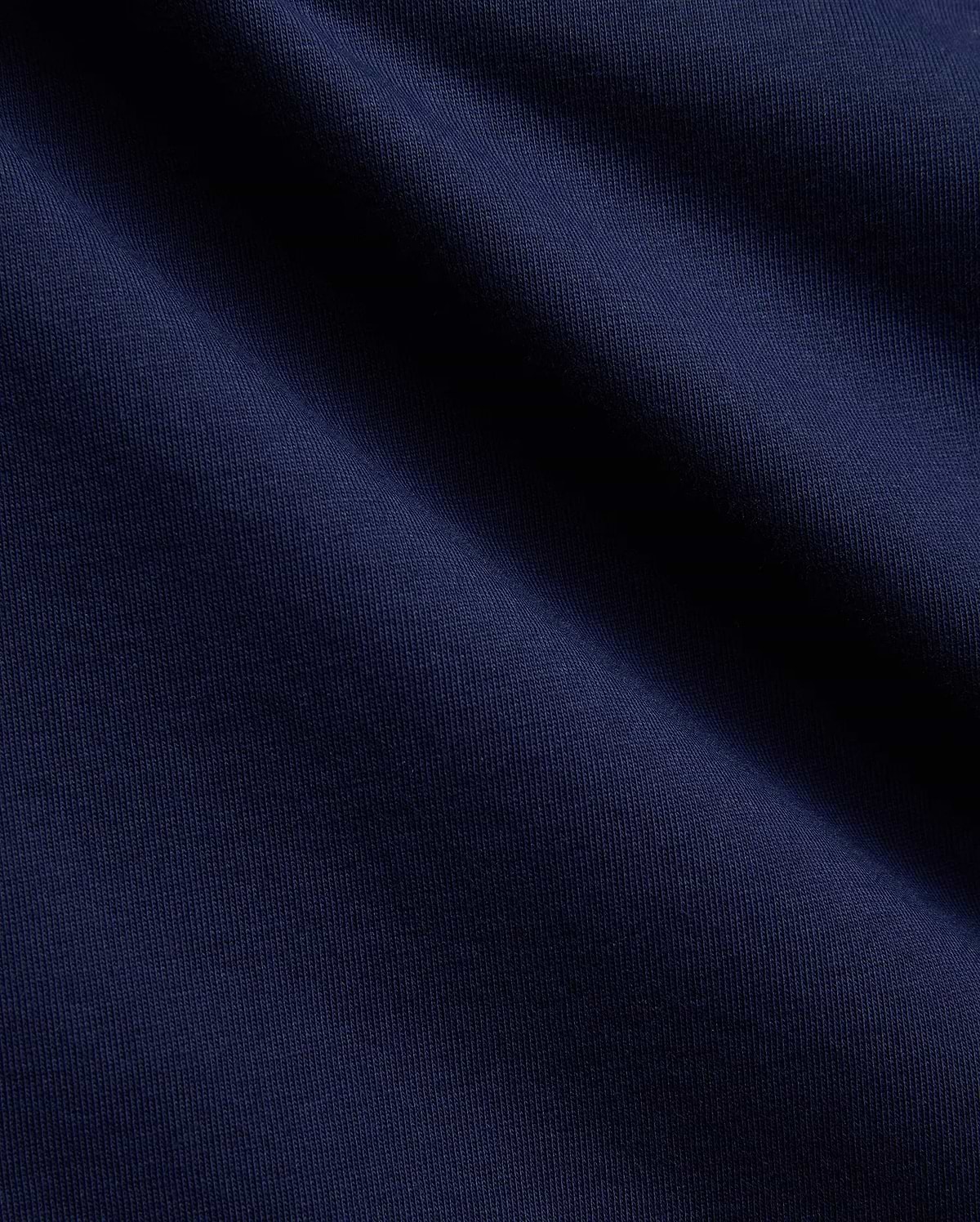 Mens Ethan Graphic Tee in a deep, luxurious navy blue, crafted from a premium, soft-touch jersey knit fabric with a subtle vertical ribbed texture, perfect for sophisticated streetwear. (2)