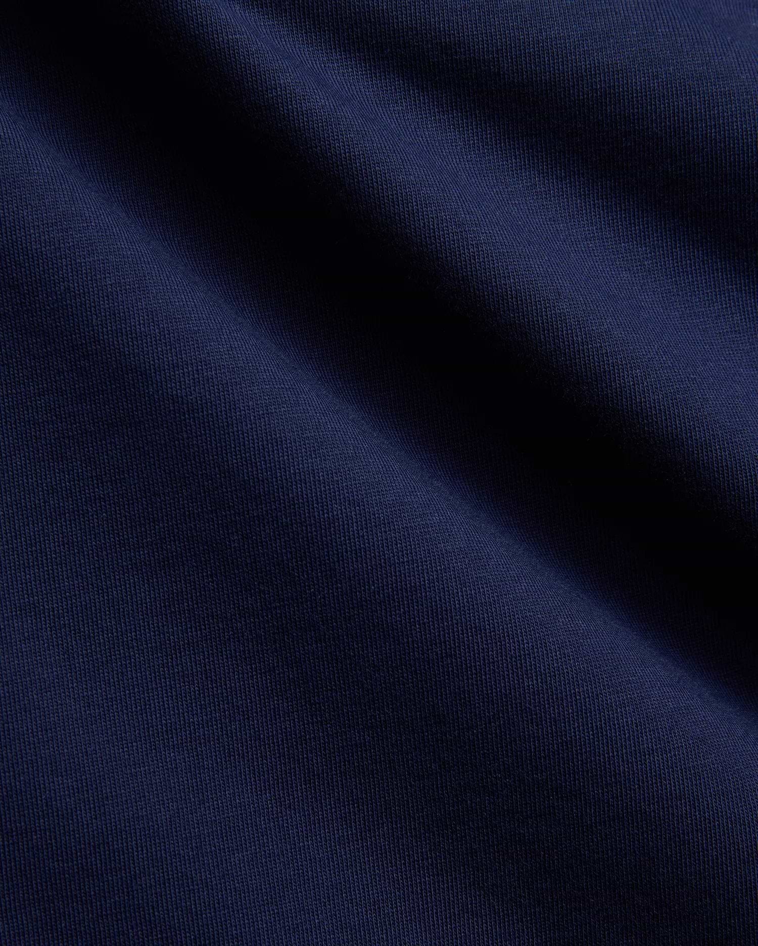 Mens Ethan Graphic Tee in a deep, luxurious navy blue, crafted from a premium, soft-touch jersey knit fabric with a subtle vertical ribbed texture, perfect for sophisticated streetwear. (2)